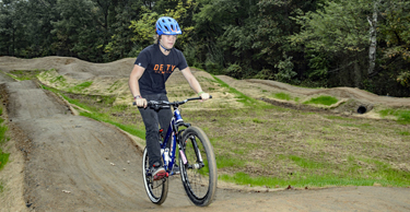 Cyclist rides up a hill on the Lake Fairfax Pump Track