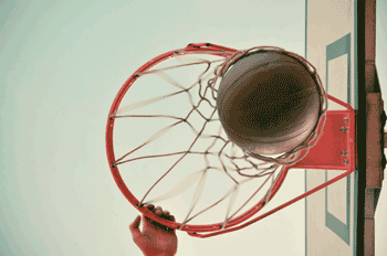 Photo of basketball going through hoop from below