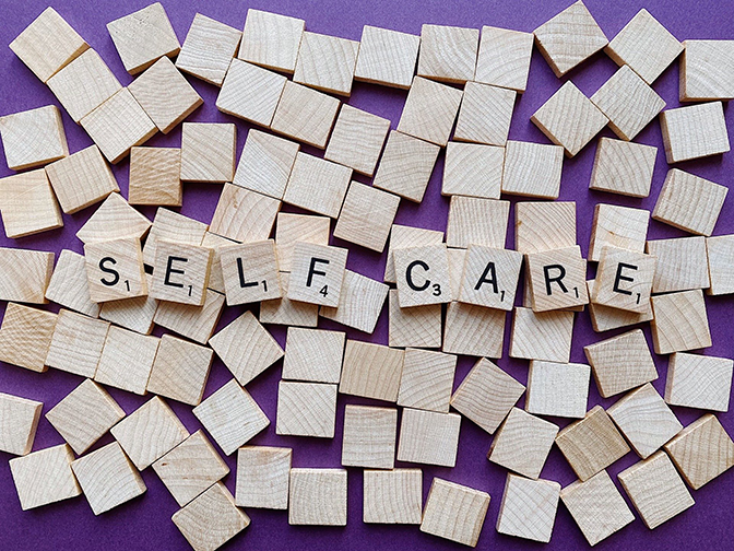 wood squares letters spell self-care