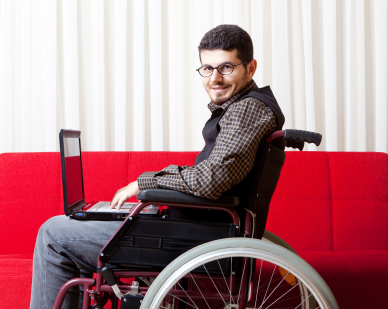 male-wheelchair-user-at-work-using-laptop