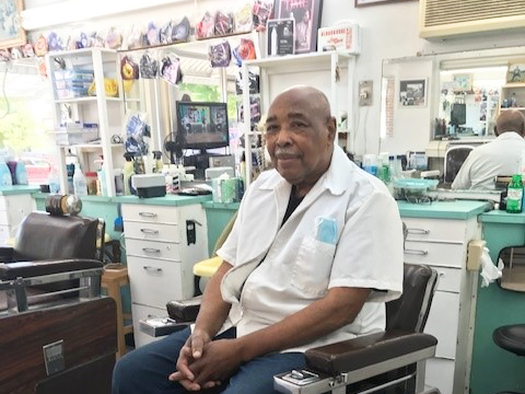 Herman "Smitty" Smith sitting in barber chair