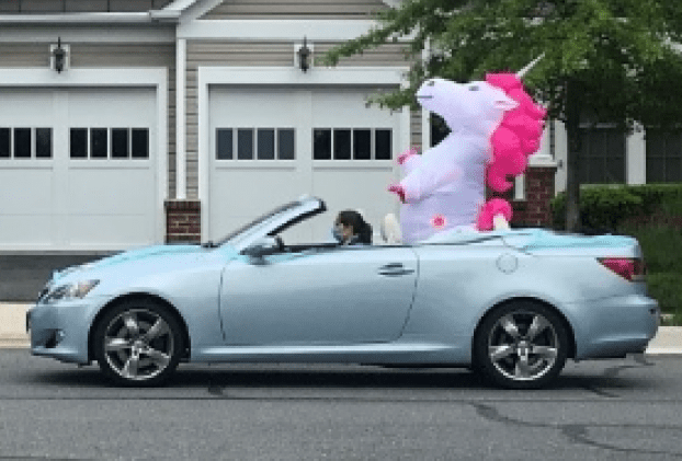 Convertable with giant inflatable unicorn  participates in Spring Hill N2N birthday parade