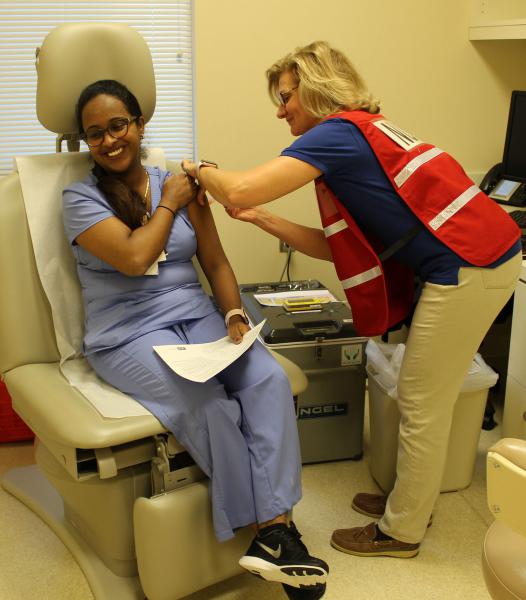 A Health Department nurse adminsters a flu shot