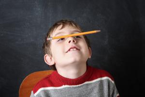 Kid with pencil on his nose