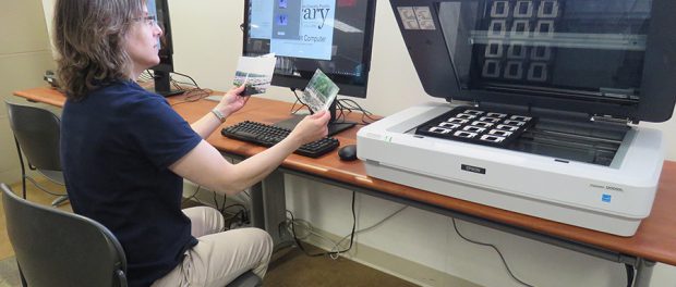 Librarian demonstrates digital transfer equipment