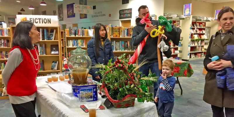 Photo of staff and families at a library holiday open house