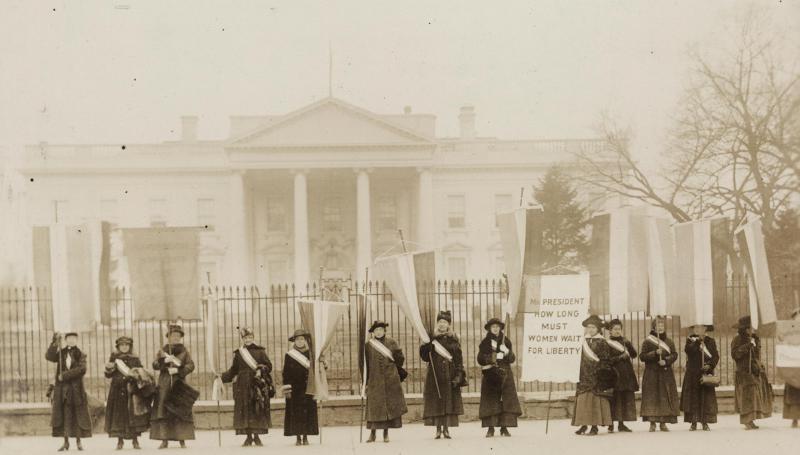 black and white photo of women picketing for the right to vote outside the White House in 1917