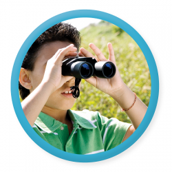 Young boy lookin through binoculars
