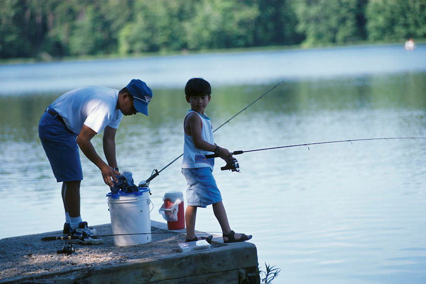 young boy fishing with his dad.jpg