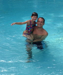 man and child in pool