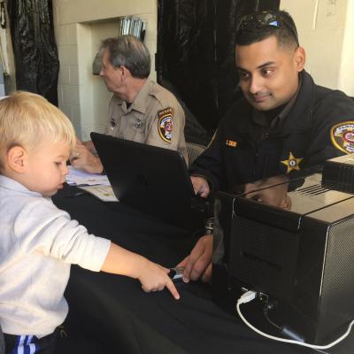 Deputy electronically fingerprints little boy