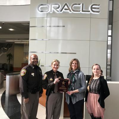 Sheriff Kincaid presents plaque to Gail Kolb at Oracle