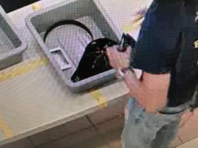 Man takes wallet out of bin