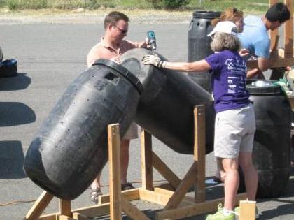 People building tumbler composters