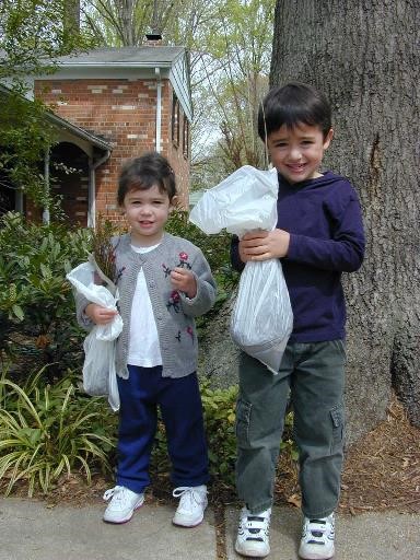 Small boy and girl hold seedling packages