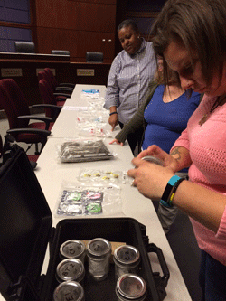 Attendees looking at drug samples