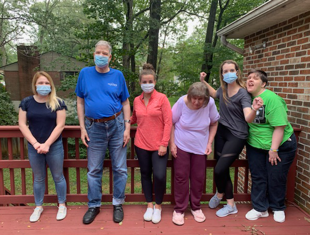 Photo of staff and residents at Midway group home outside on deck