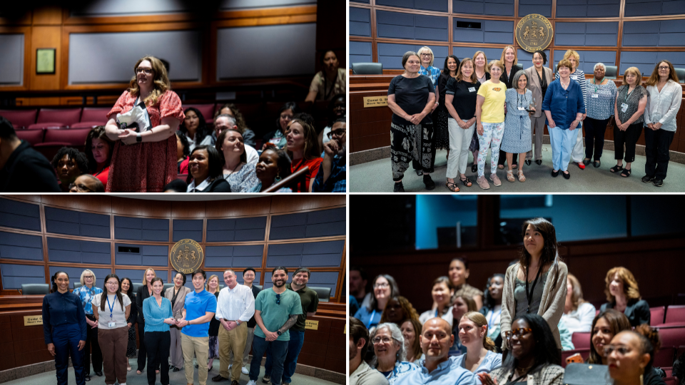 People stand and smile at the Government Center with their SOE awards