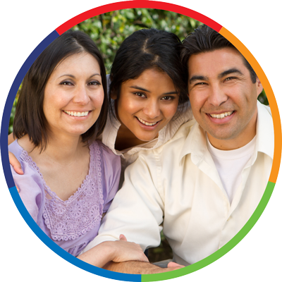 a man woman and daughter together smiling toward the photographer