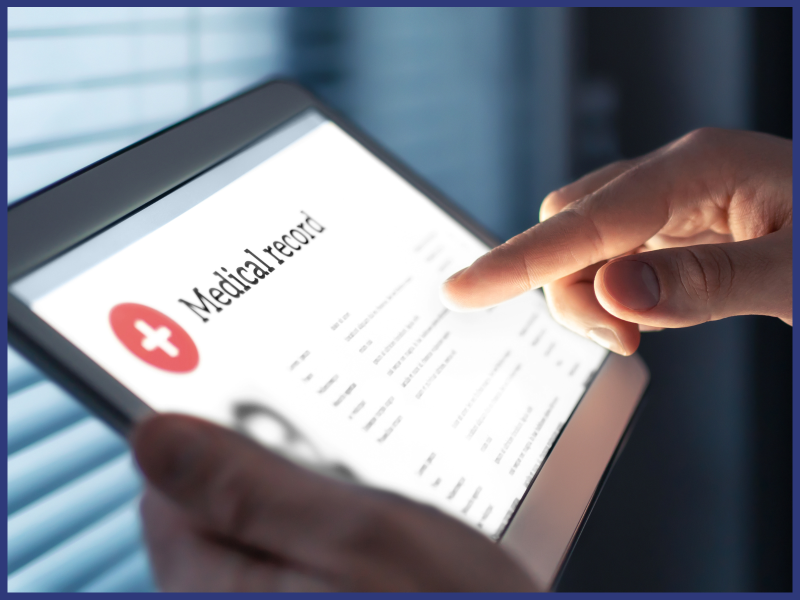 A person's hand uses a screen that says "Medical Record."