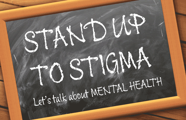 Chalkboard with "Stand up to stigma - let's talk about mental health" written on it