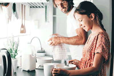 Photo of father and daughter working in kitchen together