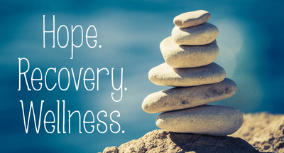 Image of balanced rocks with the words "hope, recovery, wellness"