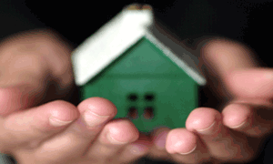 Photo of hands holding tiny house