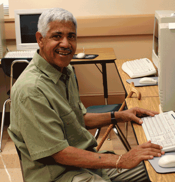 Smiling man sitting at computer