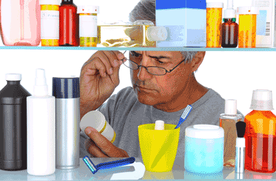 Photo of man looking at medications in his medicine cabinet