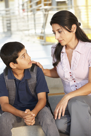 Photo of mother comforting teen boy