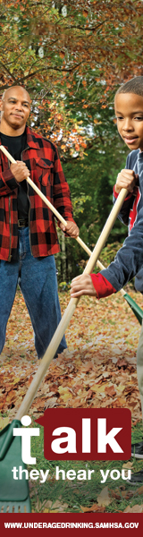 Photo of father and tween son raking leaves