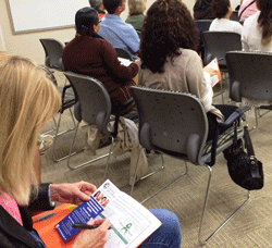 Photo audience member taking notes