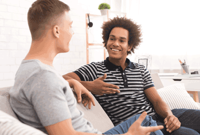 Photo of two males talking