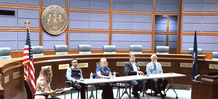 Photo of discussion panel members sitting at a table