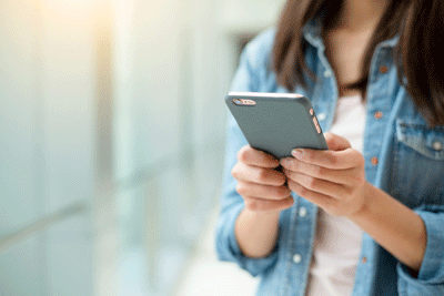 Photo of woman typing on smart phone