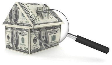 House made of money and magnifying glass