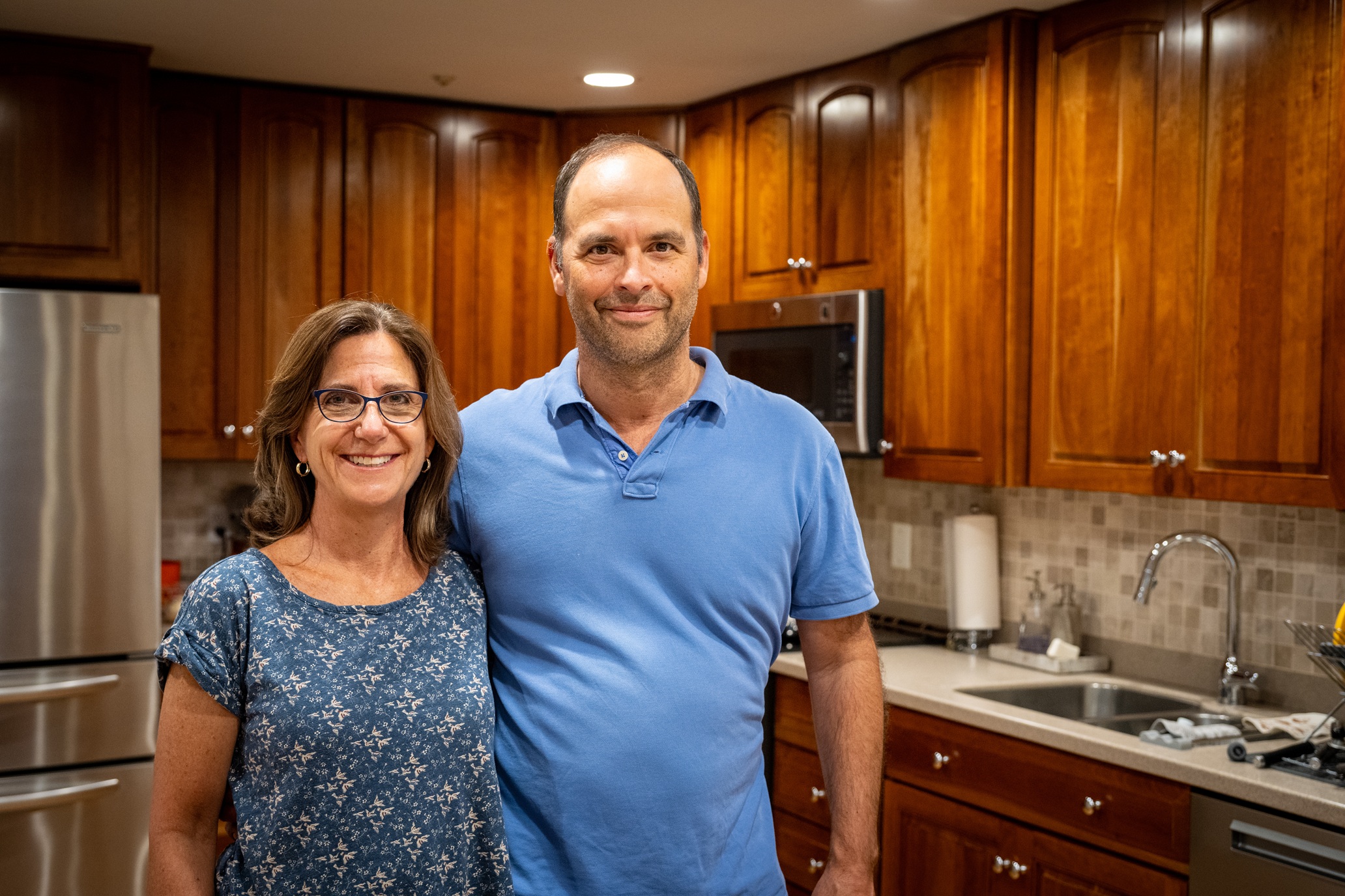 man and woman posing in their kitchen