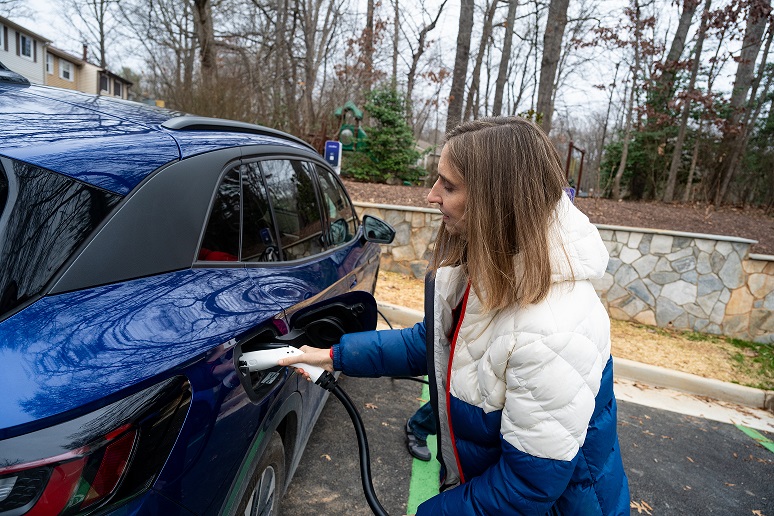 photo of author julie gurnee plugging in her new EV at a charging station