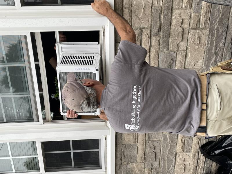 man installing a window ac unit