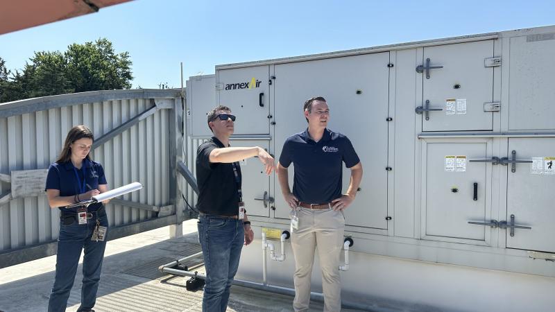 3 people standing on roof