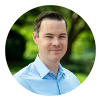 headshot of man with blue shirt