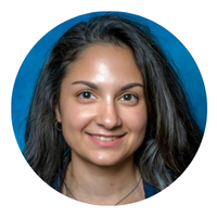 woman headshot with dark hard and blue shirt