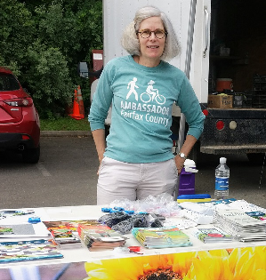woman at table with bike ambassador tshirt