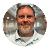 man with blue collared shirt headshot