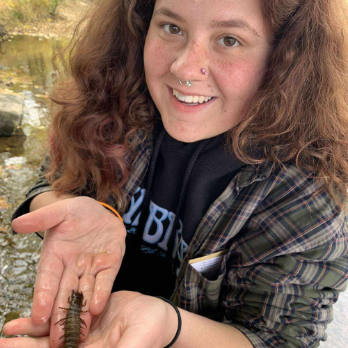 maiya justice posing with a large bug 