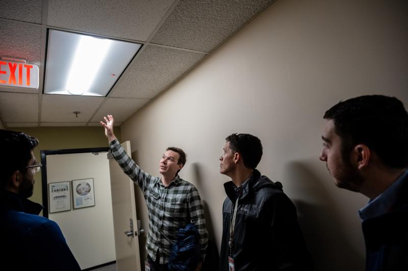 kevin smith reaching up to point out a light fixture