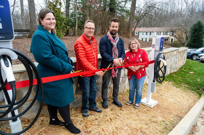 4 people participating in a ribbon cutting