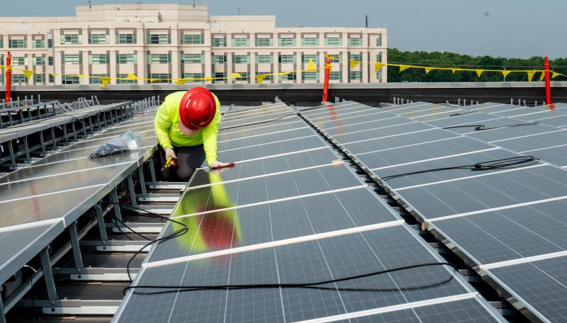 man installing solar panels