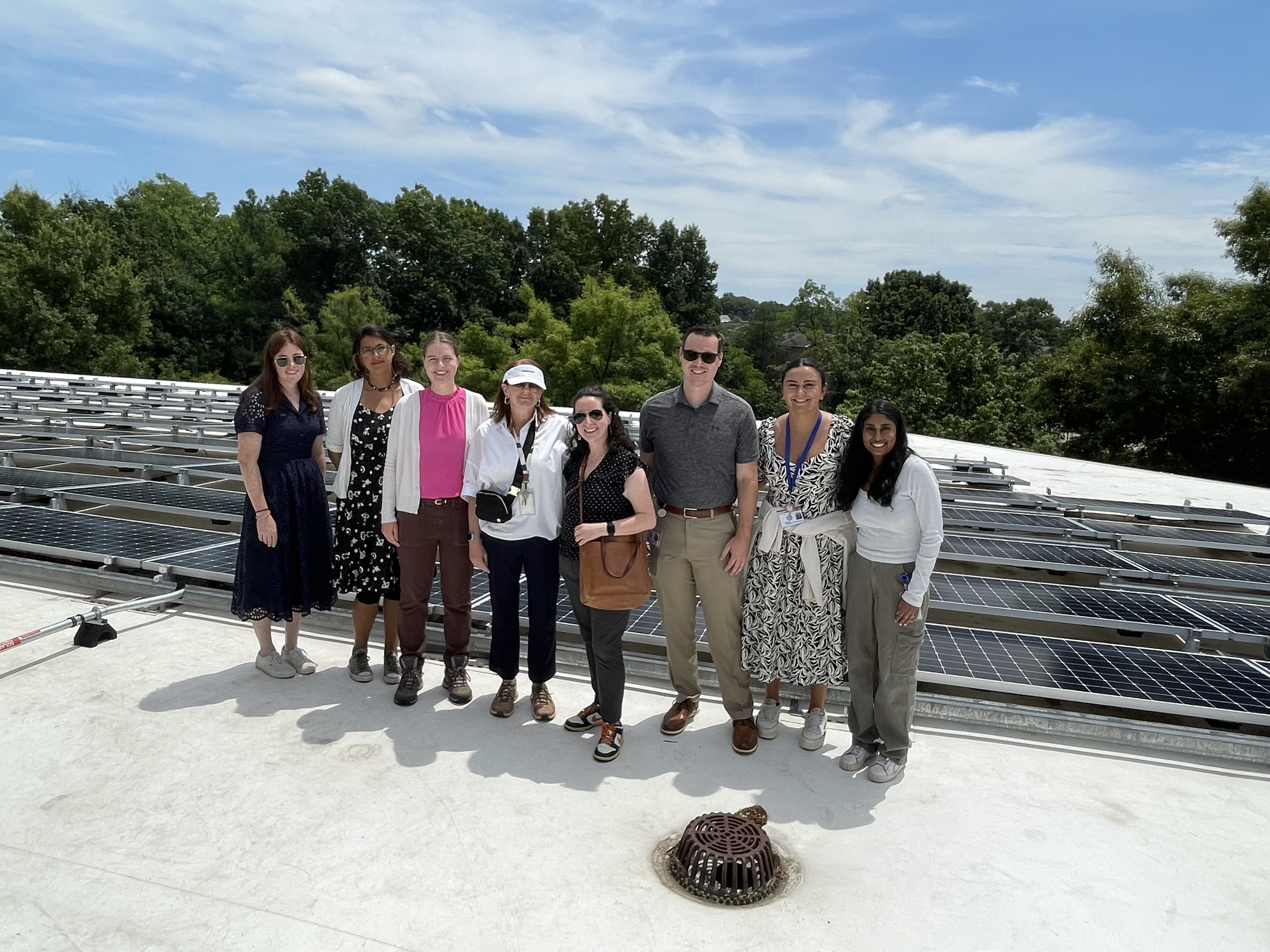 Rosalia (second from the right) with other OEEC staff taking a tour of solar panels